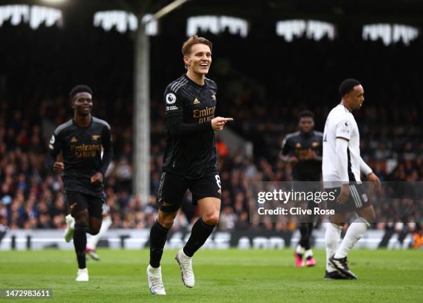 Martin Odegaard of Arsenal celebrates after scoring the team's third goal during the Premier League match between Fulham FC and Arsenal FC at Craven...