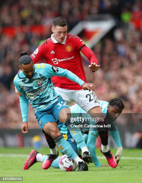 Theo Walcott of Southampton battles for possession with Wout Weghorst of Manchester United during the Premier League match between Manchester United...