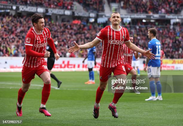 Maximilian Eggestein of Sport-Club Freiburg celebrates with teammate Michael Gregoritsch after scoring the side's first goal during the Bundesliga...