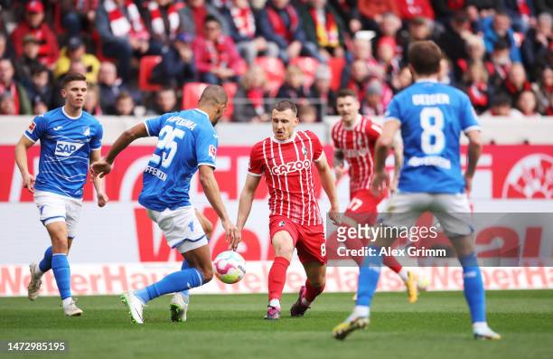 Maximilian Eggestein of Sport-Club Freiburg battles for possession with Kevin Akpoguma of TSG Hoffenheim during the Bundesliga match between...
