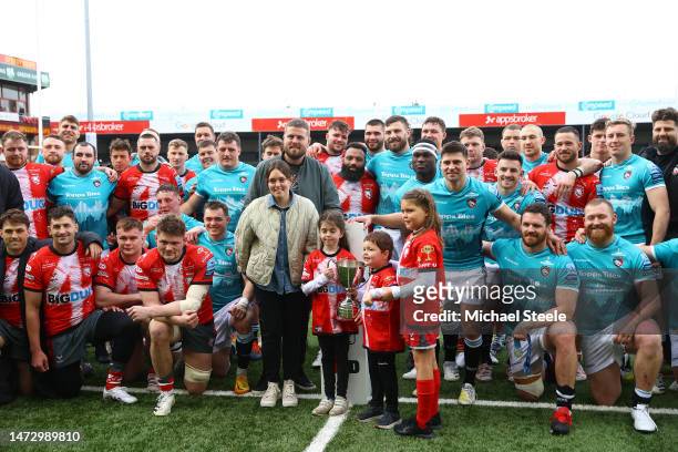 Gloucester and Leicester Tigers players gather with former player Ed Slater and his family following the Gallagher Premiership Rugby match between...