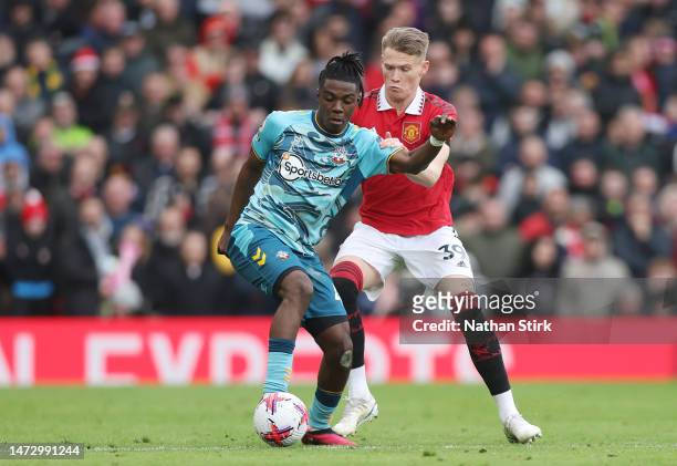 Romeo Lavia of Southampton battles for possession with Scott McTominay of Manchester United during the Premier League match between Manchester United...