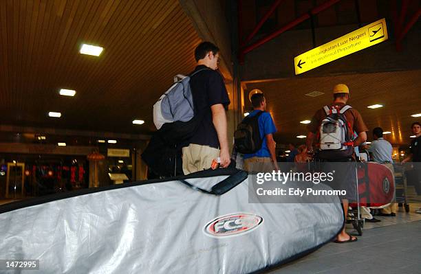 Foreigners wait in line at Ngurah Rai International Airport October 13, 2002 in Denpasar Bali, Indonesia. Foreigners began leaving Bali after a...