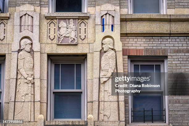 decorations of franciscan friars on a building on sixth avenue and waverly place, greenwich village, new york city - new york city waverly job center stock pictures, royalty-free photos & images