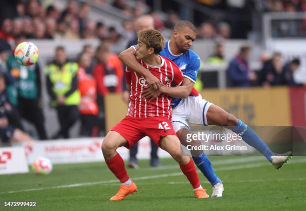 Ritsu Doan of Sport-Club Freiburg battles for possession with Kevin Akpoguma of TSG Hoffenheim during the Bundesliga match between Sport-Club...