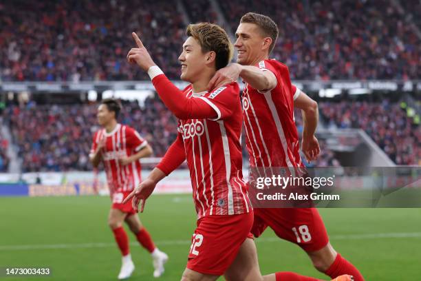 Ritsu Doan of Sport-Club Freiburg celebrates with teammate Nils Petersen after scoring the side's second goal during the Bundesliga match between...