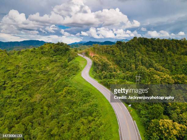 aerial view of beautiful sky road over top of mountains with green jungle in nan province, thailand. - green inspiring backgrounds imagens e fotografias de stock