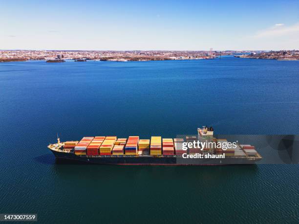 aerial view of anchored container ship - harbor east stock pictures, royalty-free photos & images