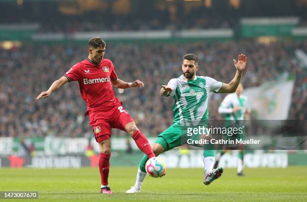 Exequiel Palacios of Bayer 04 Leverkusen battles for possession with Anthony Jung of SV Werder Bremen during the Bundesliga match between SV Werder...