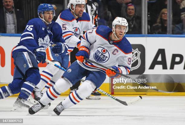 Connor McDavid of the Edmonton Oilers skates against Alexander Kerfoot of the Toronto Maple Leafs during an NHL game at Scotiabank Arena on March 11,...