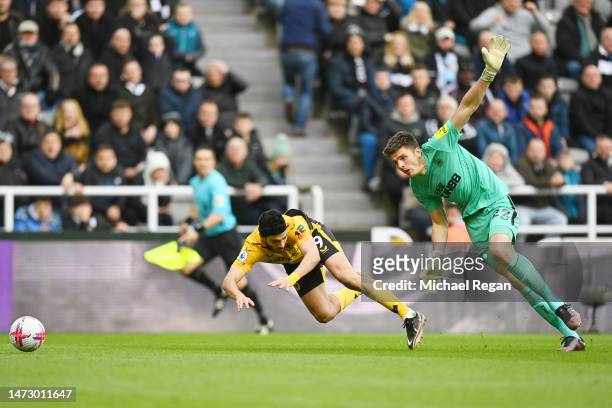 Raul Jimenez of Wolverhampton Wanderers and Nick Pope of Newcastle United collide during the Premier League match between Newcastle United and...