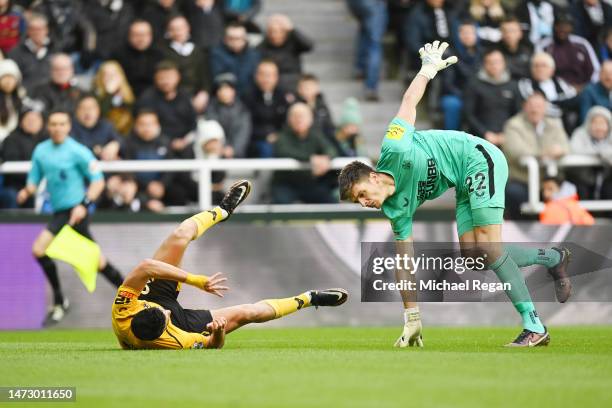 Raul Jimenez of Wolverhampton Wanderers and Nick Pope of Newcastle United collide during the Premier League match between Newcastle United and...