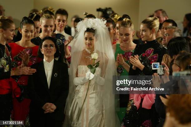 Designer Hanae Mori takes her final bow with granddaughter Izumi Mori during her fall 2004 couture collection runway show in Paris.