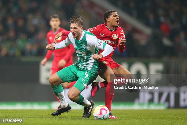 Niklas Stark of SV Werder Bremen and Amine Adli of Bayer 04 Leverkusen clash as they battle for possession during the Bundesliga match between SV...