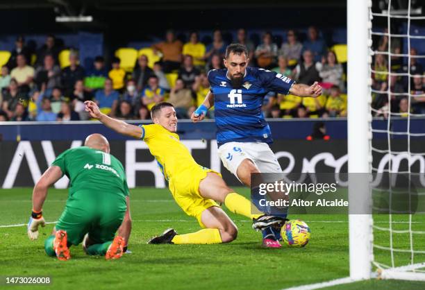 Borja Iglesias of Real Betis scores the team's first goal past Juan Foyth and Pepe Reina of Villarreal CF during the LaLiga Santander match between...