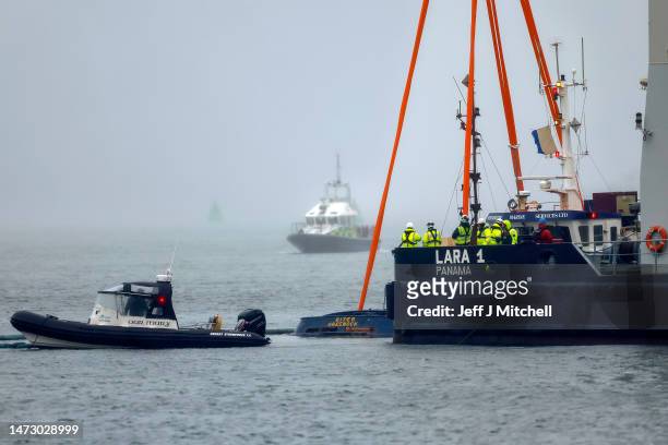 The crane ship Lara 1, from Liverpool, starts the salvage operation to recover the tugboat that capsized in the River Clyde on March 12, 2023 in...