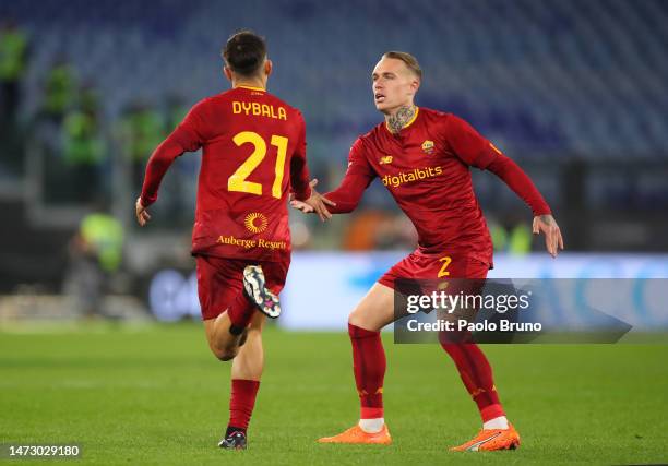 Paulo Dybala of AS Roma interacts with teammate Rick Karsdorp during the Serie A match between AS Roma and US Sassuolo at Stadio Olimpico on March...