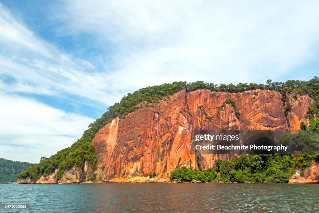 Scenic view the red cliffs of Berhala island in Sandakan, Sabah, Malaysia