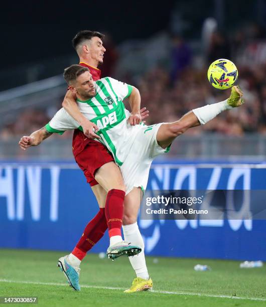 Roger Ibanez of AS Roma battles for possession with Domenico Berardi of US Sassuolo during the Serie A match between AS Roma and US Sassuolo at...