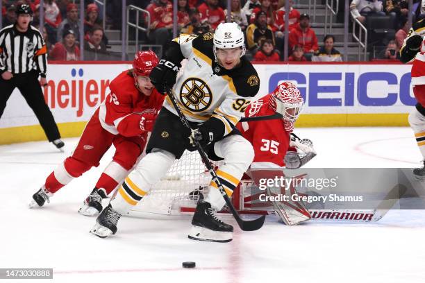 Tomas Nosek of the Boston Bruins tries to get a shot off against Ville Husso of the Detroit Red Wings during the first period at Little Caesars Arena...