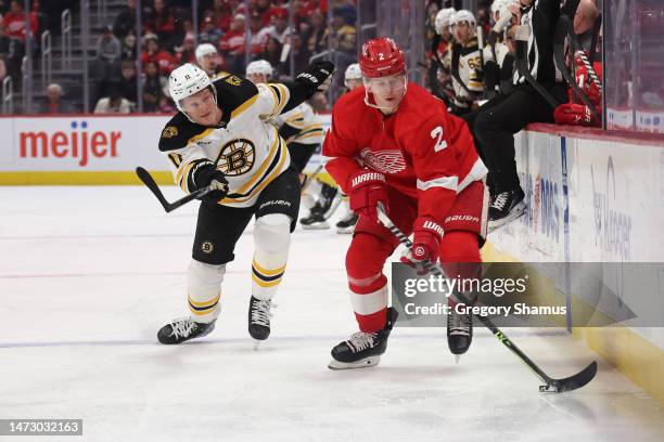 Olli Maatta of the Detroit Red Wings tries to control the puck in front of Trent Frederic of the Boston Bruins during the first period at Little...