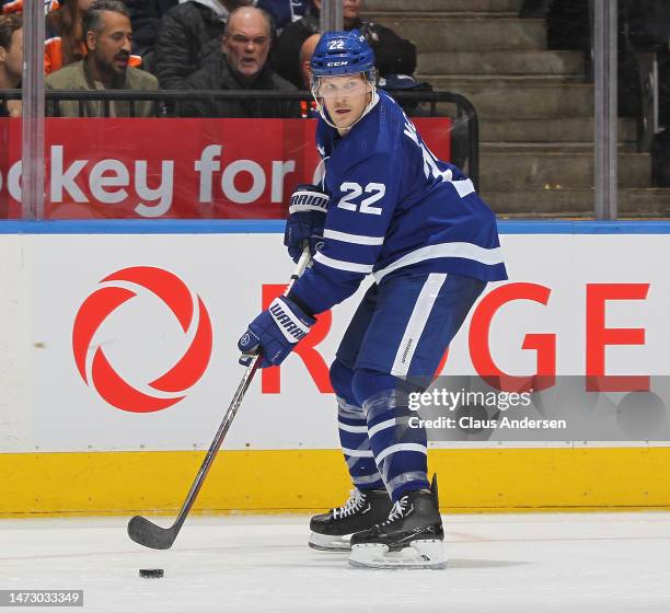 Jake McCabe of the Toronto Maple Leafs handles the puck against the Edmonton Oilers during an NHL game at Scotiabank Arena on March 11, 2023 in...