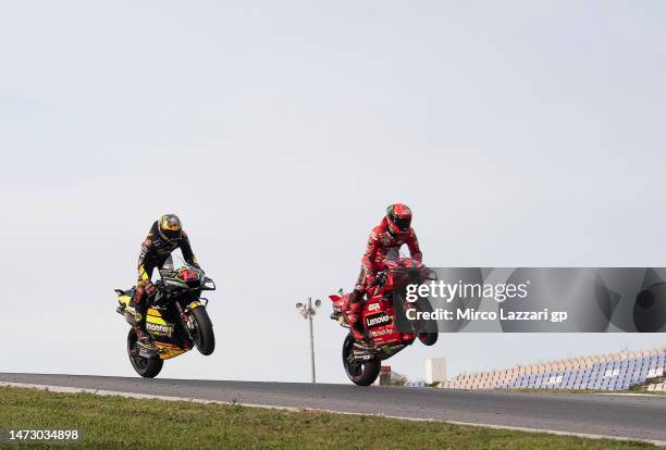 Francesco Bagnaia of Italy and Ducati Lenovo Team and Marco Bezzecchi of Italy and Mooney VR46 Racing Team lift the front wheel during the Portimao...