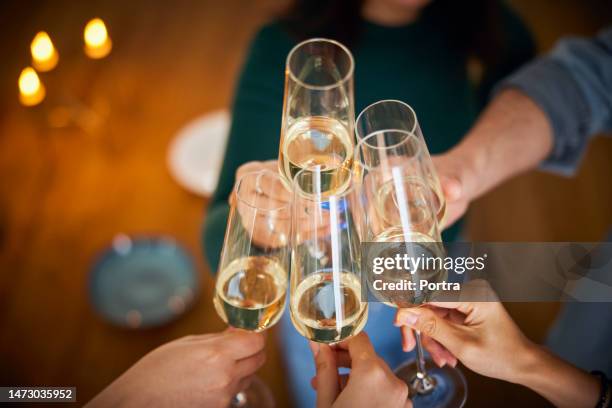 close up of friends clinking champagne glasses - champagne glasses stock pictures, royalty-free photos & images