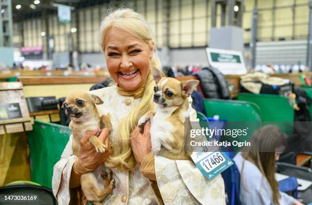 Woman holds her two Chihuahuas on day four of CRUFTS Dog Show at NEC Arena on March 12, 2023 in Birmingham, England. Billed as the greatest dog show...