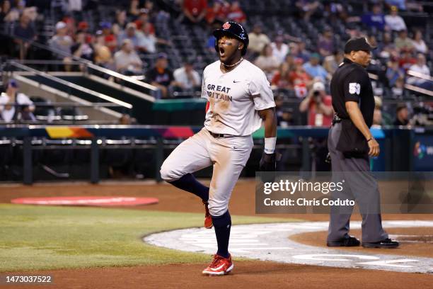 Chavez Young of Team Great Britain reacts after stealing home during the first inning of the World Baseball Classic Pool C game against Team Canada...