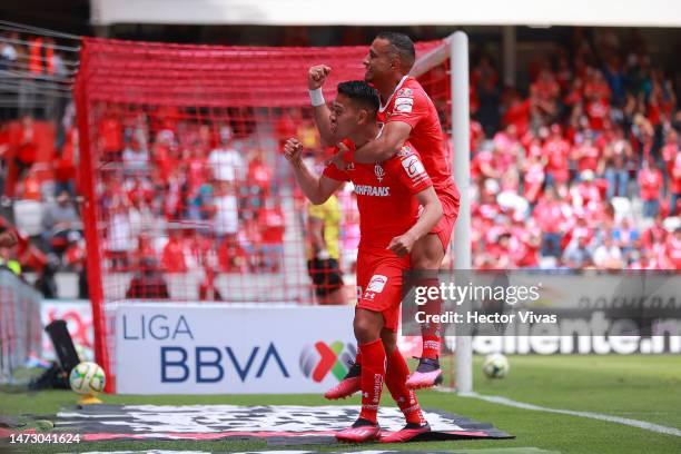 Camilo Sanvezzo of Toluca celebrates with Sebastian Saucedo of Toluca after scoring the team's fourth goal during the 11th round match between Toluca...