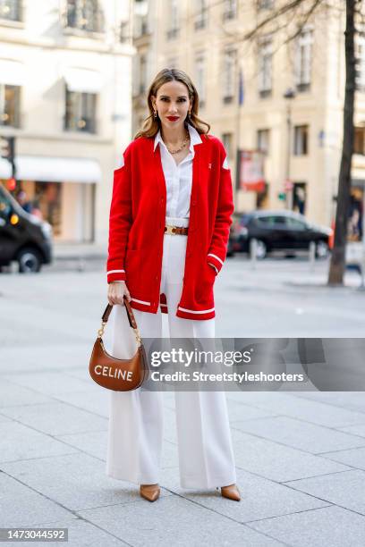 Alexandra Lapp is seen wearing GIVENCHY cut-out shoulder cardigan in red, JIL SANDER blouse in white, MAX MARA wide legged pants in creme, CELINE...