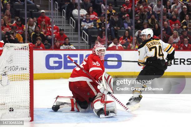 Jake DeBrusk of the Boston Bruins scores a third period goal past Ville Husso of the Detroit Red Wings at Little Caesars Arena on March 12, 2023 in...