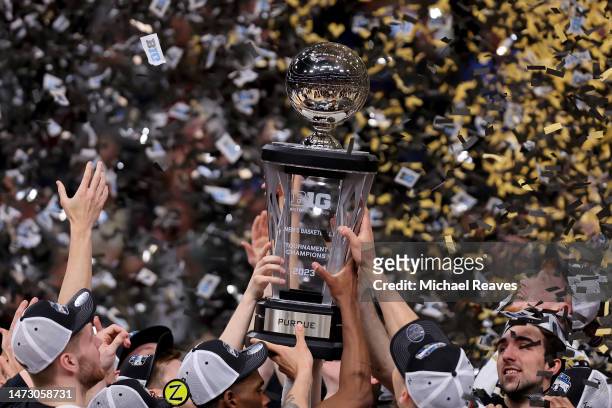 The Purdue Boilermakers celebrate with the trophy after defeating the Penn State Nittany Lions in the Big Ten Basketball Tournament Championship game...