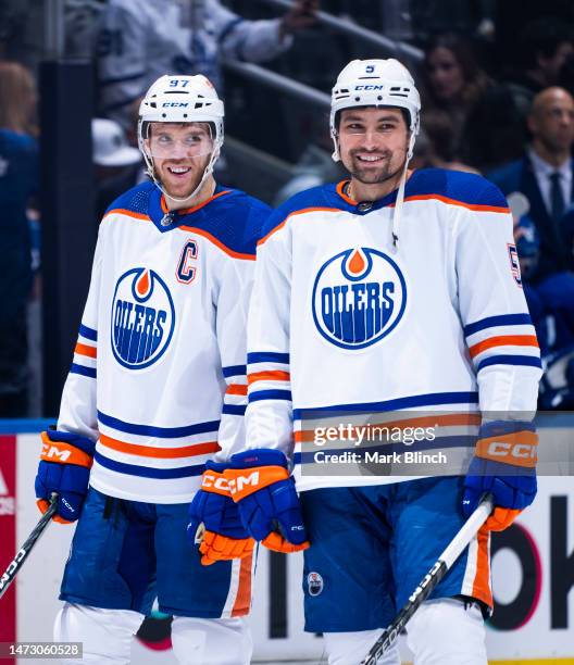 Connor McDavid and Cody Ceci of the Edmonton Oilers look on ahead of playing the Toronto Maple Leafs during the first period at the Scotiabank Arena...