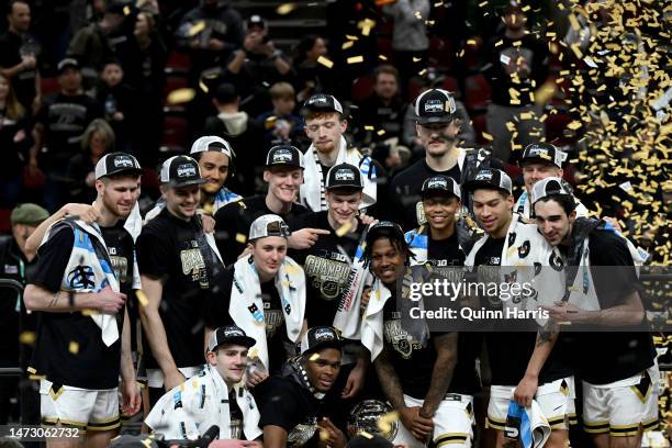 The Purdue Boilermakers celebrate with the trophy after defeating the Penn State Nittany Lions in the Big Ten Basketball Tournament Championship game...