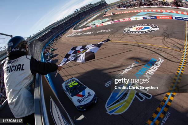 William Byron, driver of the Valvoline Chevrolet, takes the checkered flag to win the NASCAR Cup Series United Rentals Work United 500 at Phoenix...