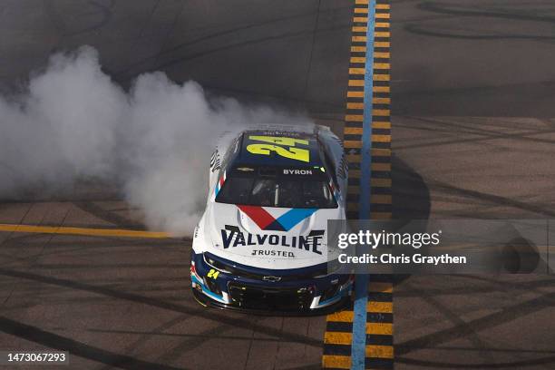 William Byron, driver of the Valvoline Chevrolet, celebrates with a burnout after winning the NASCAR Cup Series United Rentals Work United 500 at...