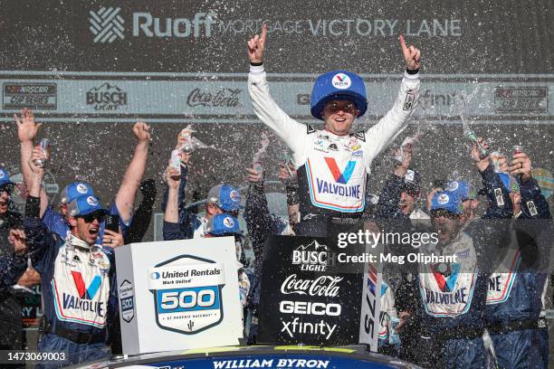 William Byron, driver of the Valvoline Chevrolet, celebrates in victory lane after winning the NASCAR Cup Series United Rentals Work United 500 at...