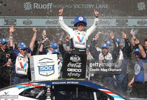 William Byron, driver of the Valvoline Chevrolet, celebrates in victory lane after winning the NASCAR Cup Series United Rentals Work United 500 at...
