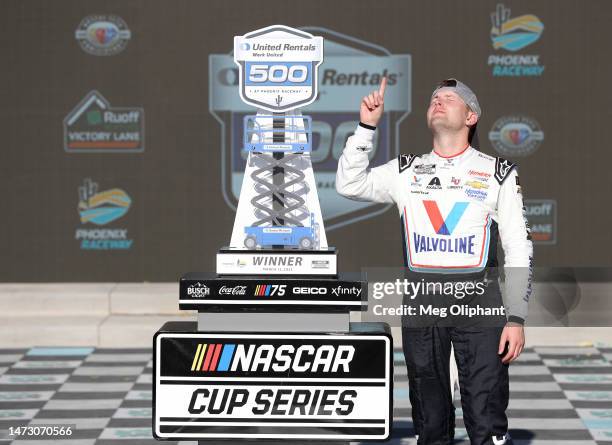 William Byron, driver of the Valvoline Chevrolet, celebrates in victory lane after winning the NASCAR Cup Series United Rentals Work United 500 at...