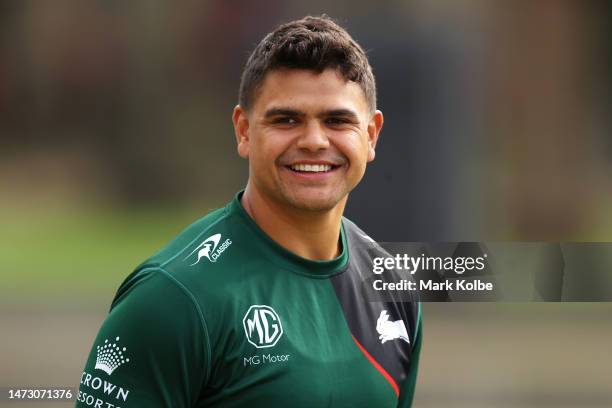 Latrell Mitchell smiles as he speaks to a team mate during a South Sydney Rabbitohs NRL training session at Redfern Oval on March 13, 2023 in Sydney,...