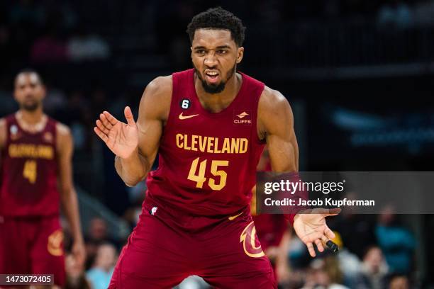 Donovan Mitchell of the Cleveland Cavaliers celebrates after making a basket in the fourth quarter during their game against the Charlotte Hornets at...