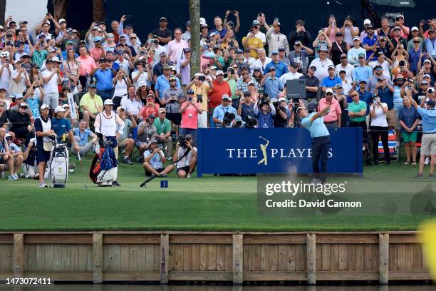 Scottie Scheffler of The United States plays his tee shot on the 17th hole during the final round of THE PLAYERS Championship on THE PLAYERS Stadium...