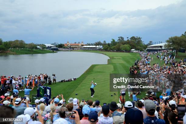 Scottie Scheffler of The United States plays his tee shot on the 18th hole during the final round of THE PLAYERS Championship on THE PLAYERS Stadium...