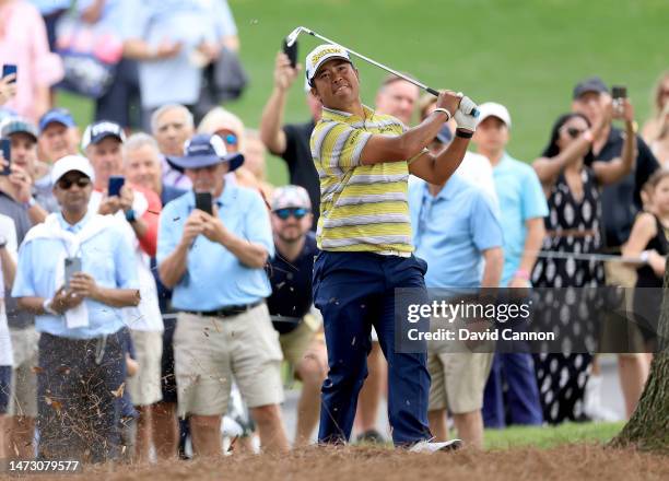 Hideki Matsuyama of Japan plays his second shot on the 18th hole during the final round of THE PLAYERS Championship on THE PLAYERS Stadium Course at...