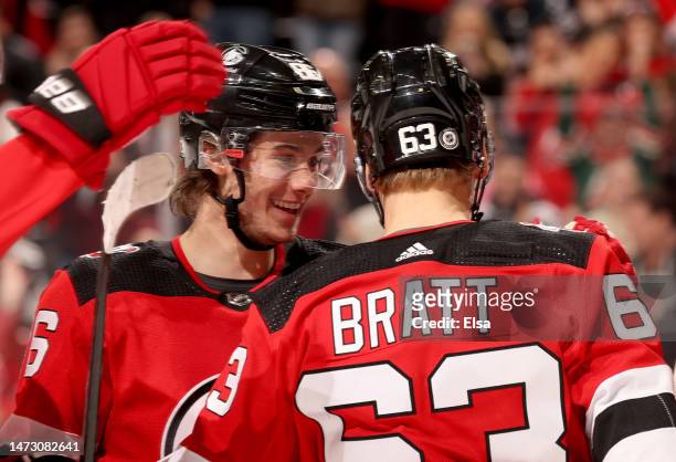 Jesper Bratt of the New Jersey Devils is congratulated by teammate Jack Hughes after Bratt scored a goal during the second period against the...