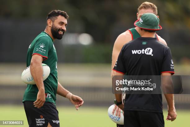 Alex Johnston laughs as he speaks to team mates during a South Sydney Rabbitohs NRL training session at Redfern Oval on March 13, 2023 in Sydney,...
