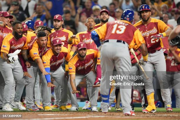 Salvador Perez of Venezuela celebrates with teammates after hitting a home run in the second inning against Puerto Rico at loanDepot park on March...