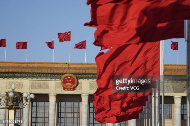 Chinese national flags flutter in front of the Great Hall during the fifth plenary meeting of the first session of the 14th National People's...